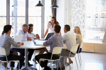 Colleagues gathered around conference table